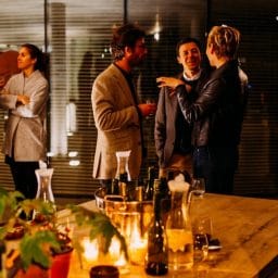 People talking at a dinner party.