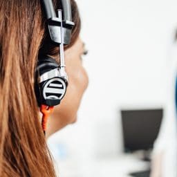 Woman wearing headphones and taking a hearing test.