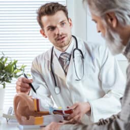Doctor talking to an older patient about hearing loss.