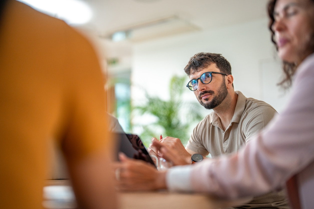 Man listens in a meeting
