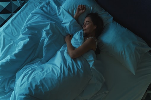 Woman sleeping peacefully in her bed at night.
